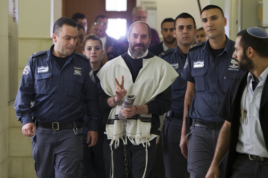 american born israeli settler yaakov jack teitel flashes the quot v quot for victory sign as he arrives for his trial at the jerusalem district court on april 9 2013 photo afp