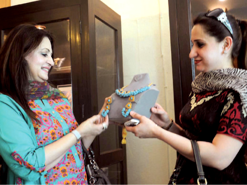 actor laila zubeiri has a look at a necklace on display photo express