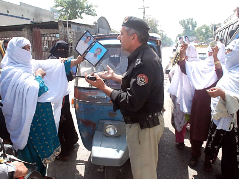 loved ones of the missing persons hold up photos demanding their release photo muhammad iqbal express