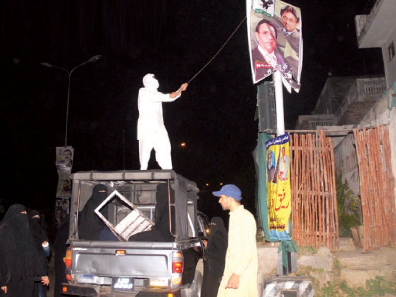 around 20 burqa clad women and 10 men took off the party s posters from lampposts in aabpara market photo online