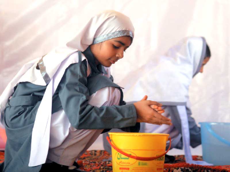 students of the kmc government primary school demonstrated how to wash hands during the play day at the baloch hall lyari on saturday photo athar khan express