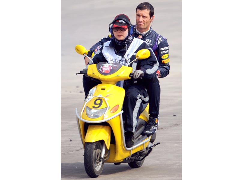 red bull s mark webber was reduced to taking a lift on a motorscooter after his car broke down during qualifying photo afp