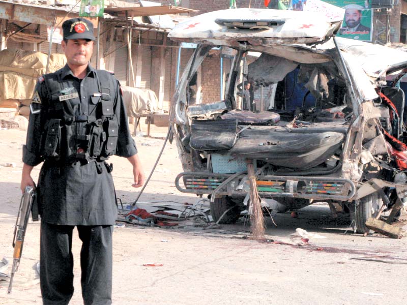 a policeman stands guard in front of the passenger coach damaged in the blast photo iqbal mamound express