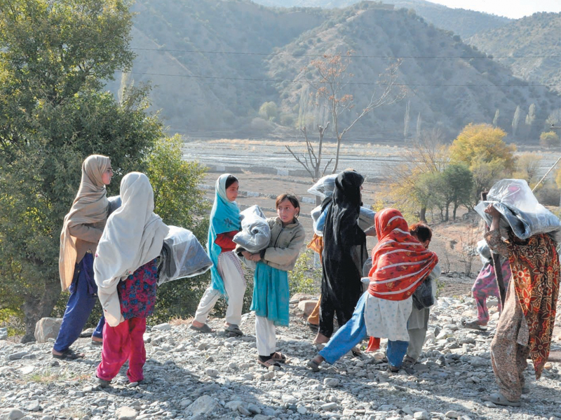 girls carry blankets distributed by the local army officers in south waziristan majority of the agency s tribesmen remain displaced since the military operations commenced in 2009 photo tahir khan express