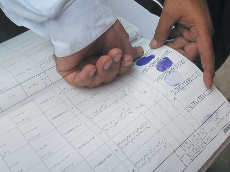 residents of gulshan e iqbal block 13 fill out their forms for the election commission staff when they made rounds of various neighbourhoods in the city sometimes with rangers deployment the verification of electoral rolls was carried out till early march photo file