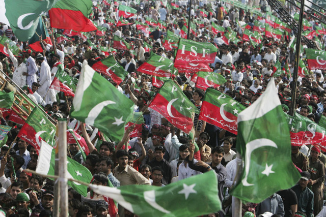 supporters of pakistan tehreek e  insaf pti wave national and party flags during a rally in lahore march 23 2013 photo reuters