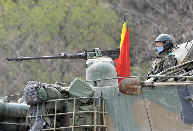 a south korean soldier sits on the top of a k 55 self propelled howitzer in the border city of paju on april 16 2013 photo afp