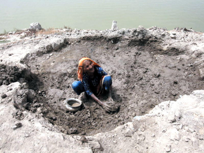 a 90 year old woman sabi bibi whose home was destroyed in floods that occurred in sindh in 2010 digs mud to build a house for herself on july 29 2011 in khairpur photo file