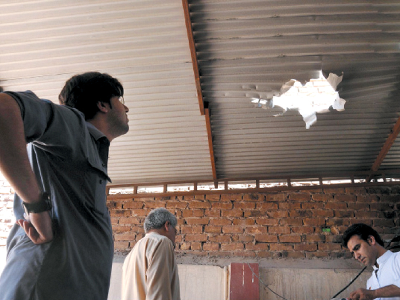 people inspect damages resulting from the attack on the house of pakistan peoples party s na 1 candidate zulfiqar afghani as the polls draw closer militants have increasingly targeted election candidates photo inp