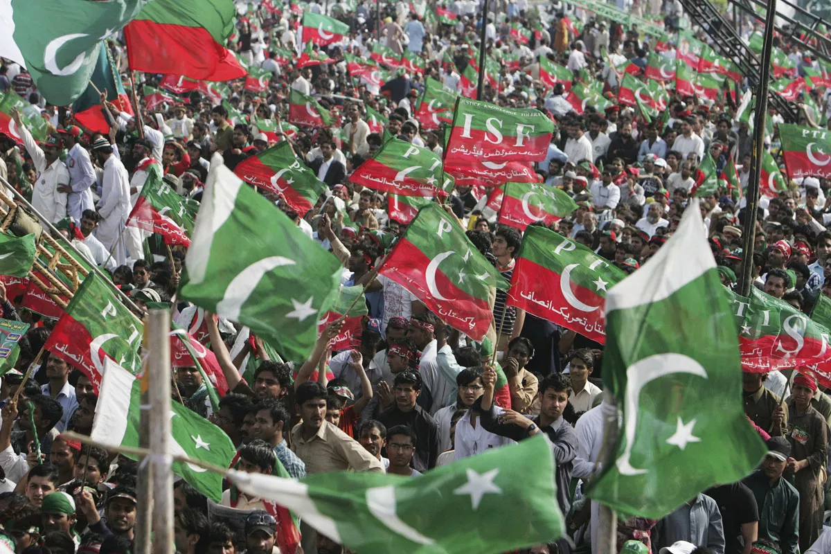 supporters of pakistan tehreek e insaf pti wave national and party flags during a rally in lahore march 23 2013 photo reuters supporters of pakistan tehreek e insaf pti wave national and party flags during a rally in lahore march 23 2013 photo reuters