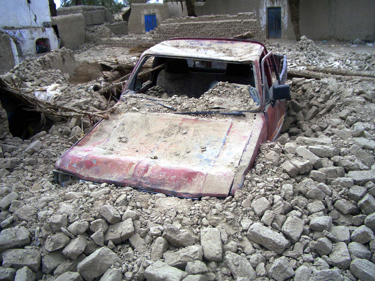 a destroyed car is seen in the rubble after an earthquake in the town of mashkeel balochistan near the iranian border april 17 2013 photo reuters