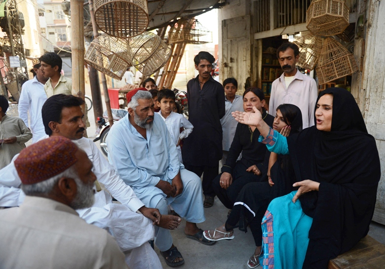 this photograph taken on april 5 2013 shows sanam faqeer r an independent candidate for forthcoming general elections speaking with local residents while campaigning in sukkur photo afp