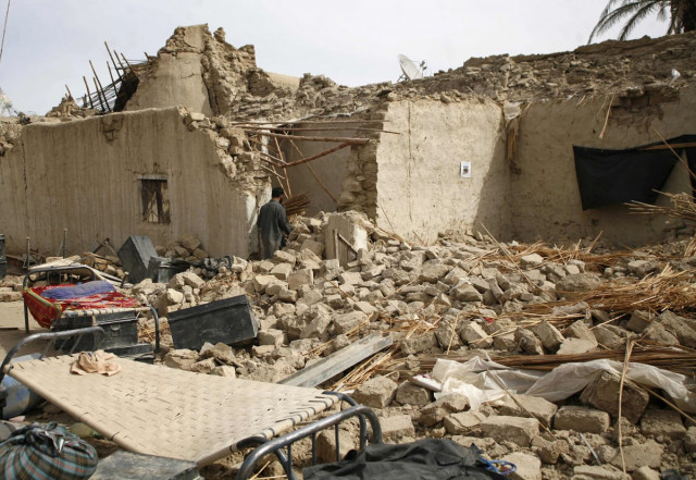 survivors of an earthquake walk on rubble of a mud house after it collapsed following the quake in the town of mashkeel balochistan near the iranian border april 17 2013 photo reuters survivors of an earthquake walk on rubble of a mud house after it collapsed following the quake in the town of mashkeel balochistan near the iranian border april 17 2013 photo reuters
