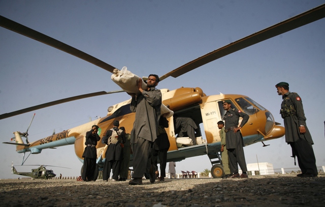 a paramilitary soldier carries a tent for survivors of an earthquake after unloading it from a helicopter in the town of mashkeel balochistan near the iranian border april 18 2013 photo reuters