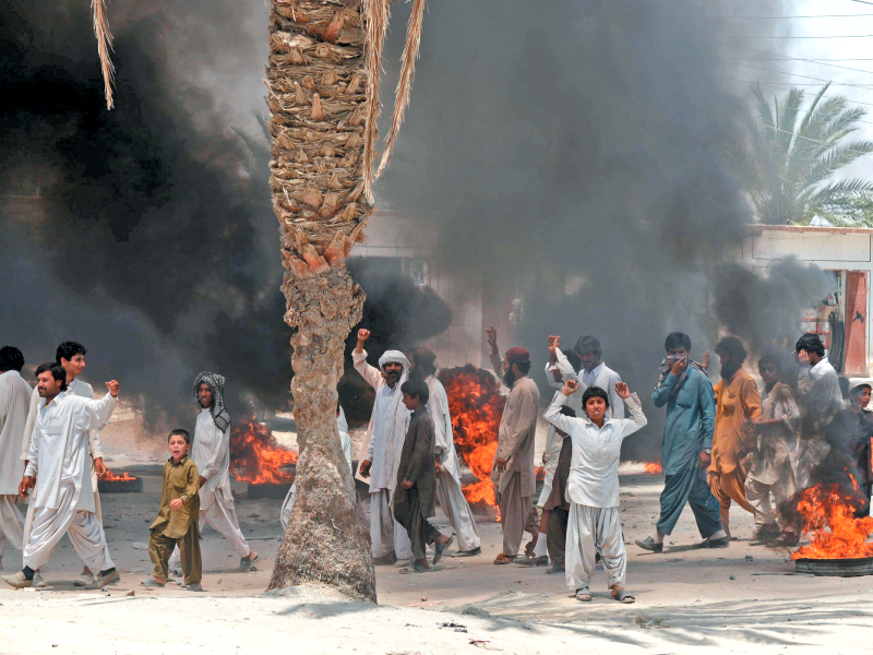 quake survivors victims protest against the government for failing to provide adequate relief in mashkhel photo afp