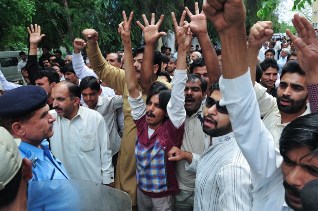 supporters of pakistani former military ruler pervez musharraf shout slogans outside the anti terrorism court during the court proceedings in islamabad district courts photo afp farooq naeem