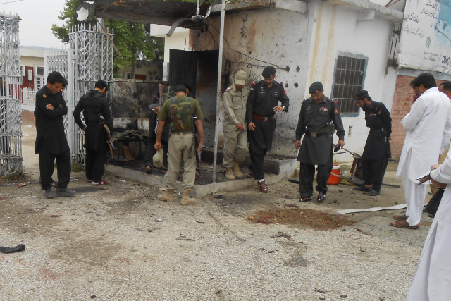 security officials inspect the site of the suicide blast in bajaur photo express security officials inspect the site of the suicide blast in bajaur photo express