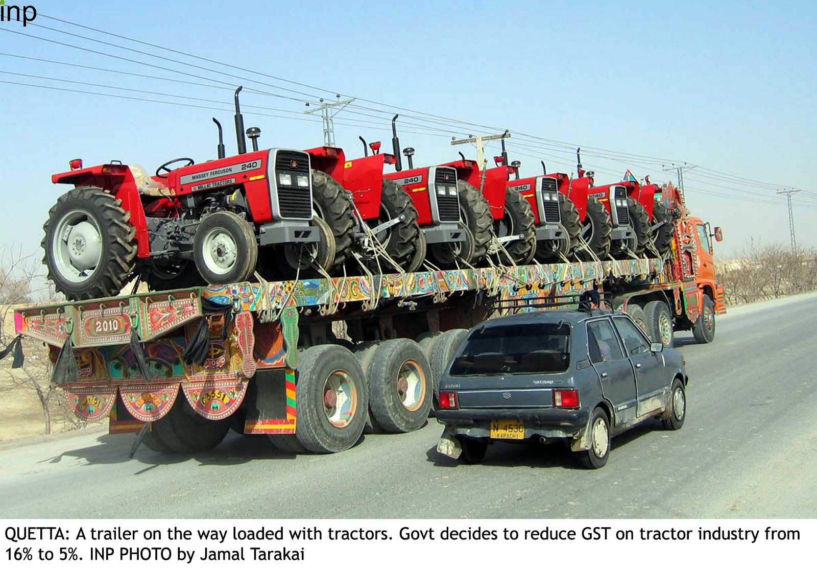 a trailer loaded with brand new tractors on their way for delivery photo inp