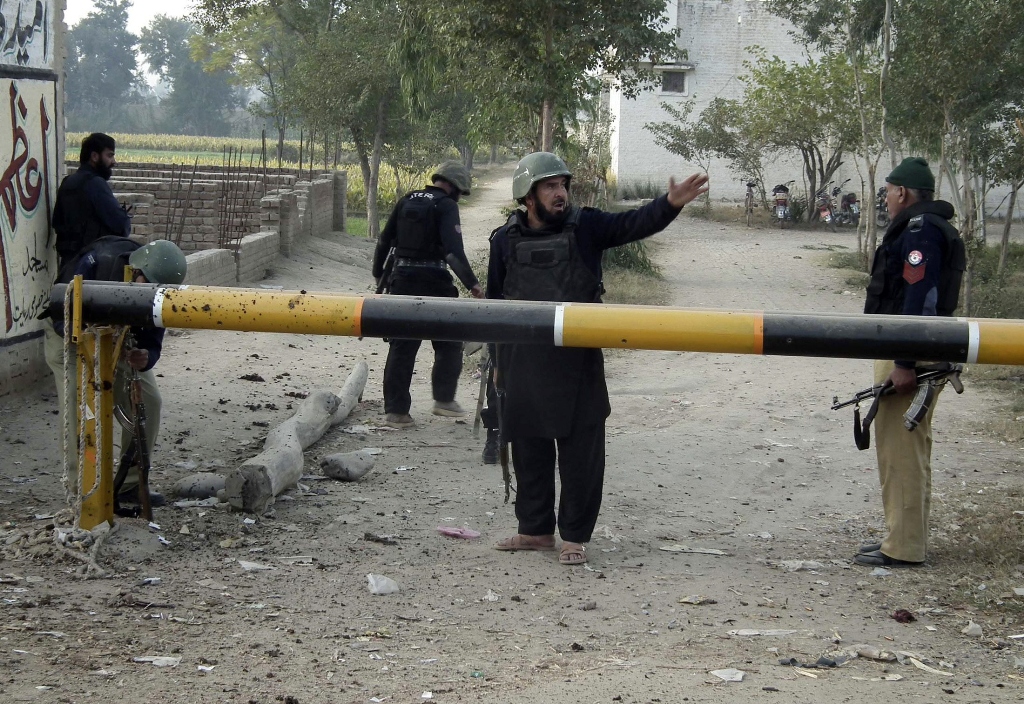 a member of security forces shouts and gestures at the entrance of a police station after a suicide bomb attack in bannu december 10 2012 photo reuters