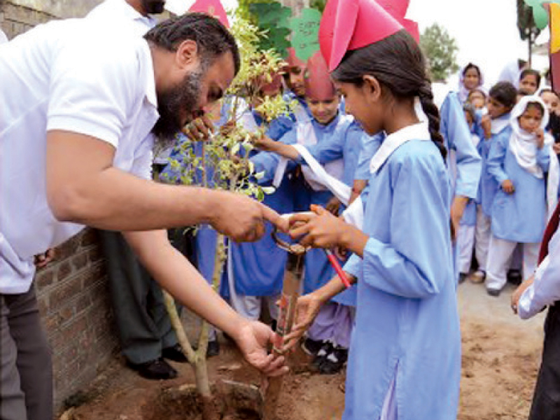 schoolchildren participating in the tree plantation drive at serena hotel on monday photo express