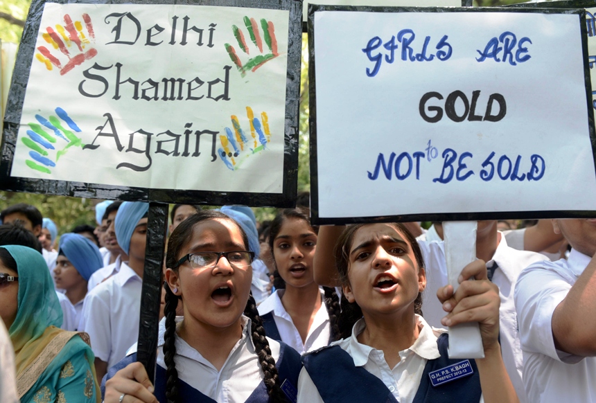 indian schoolchildren and teachers shout slogans as they carry placards during a demonstration against the rape of a five year old girl near parliament in new delhi on april 23 2013 photo afp