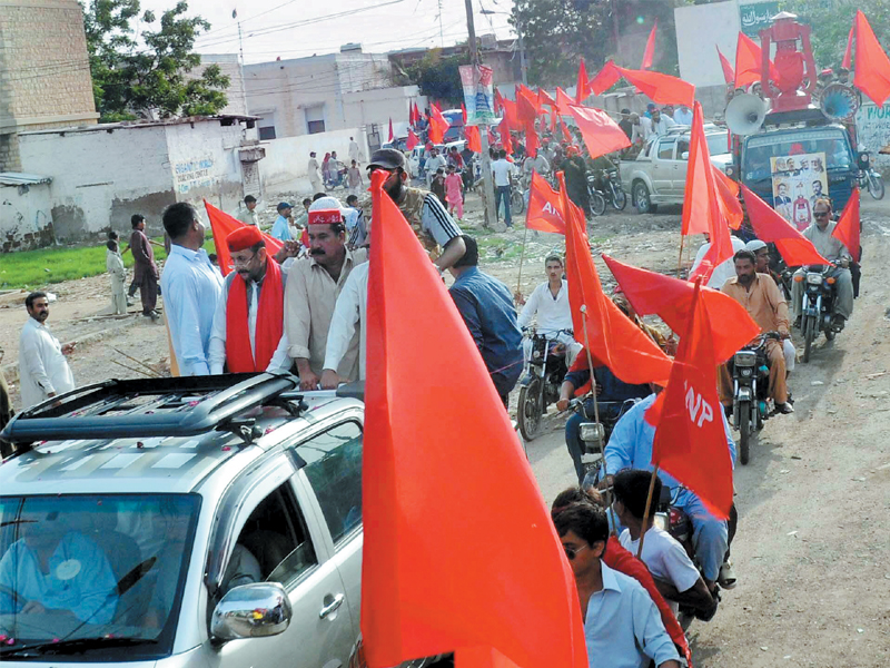 awami national party activists take part in a procession near the railway city colony to gather support before the elections photo express mohammad saqib