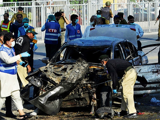 security officials inspect a destroyed vehicle after an explosion in lahore photo afp security officials inspect a destroyed vehicle after an explosion in lahore photo afp