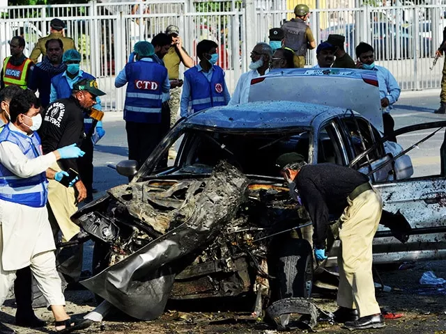 security officials inspect a destroyed vehicle after an explosion in lahore photo afp security officials inspect a destroyed vehicle after an explosion in lahore photo afp