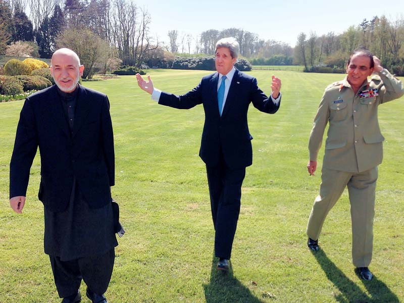 secretary kerry president karzai and general kayani take a stroll in the garden of us envoy s residence photo afp