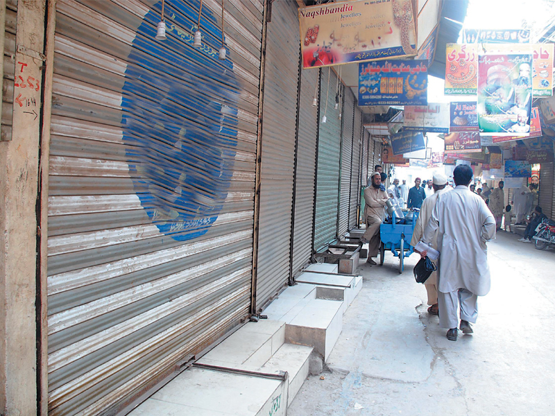 traders staged a sit in outside the market and blocked hospital road photo muhammad iqbal express