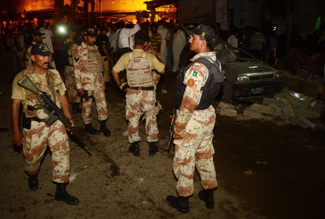 rangers examine the site of the bomb explosion outside an mqm office in karachi on april 25 2013 photo afp