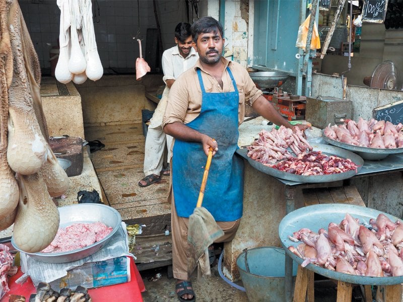 a man sells meat at raja bazaar in rawalpindi pakistan photo shutterstock