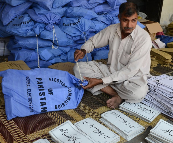 an election commission worker packs documents for polling stations in their bags for general elections photo afp file an election commission worker packs documents for polling stations in their bags for general elections photo afp file
