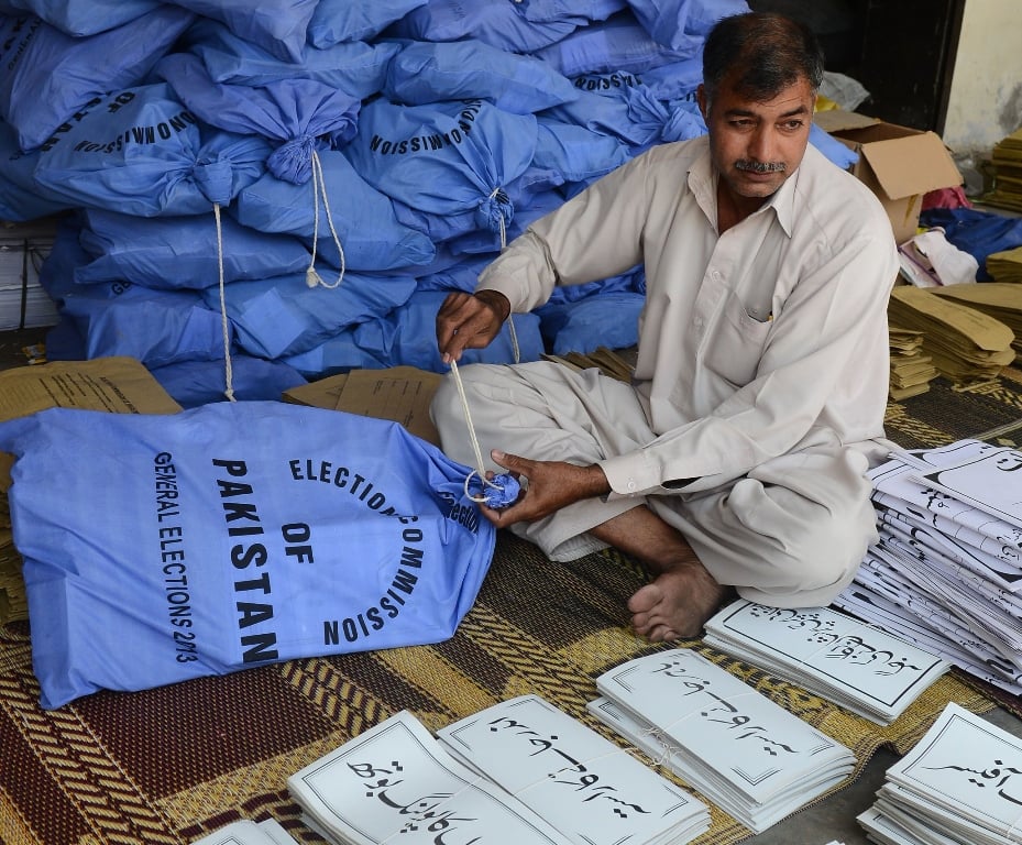 an election commission worker packs documents for polling stations in their bags for general elections photo afp file