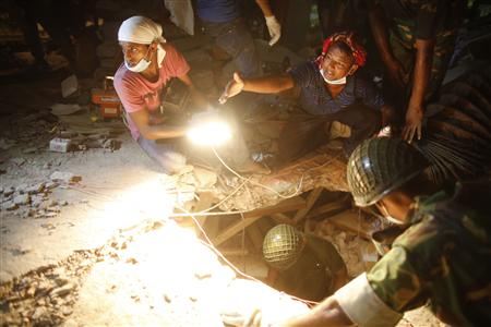 rescue workers look for trapped garment workers at the collapsed rana plaza building in savar 30 km outside dhaka april 26 2013 photo reuters