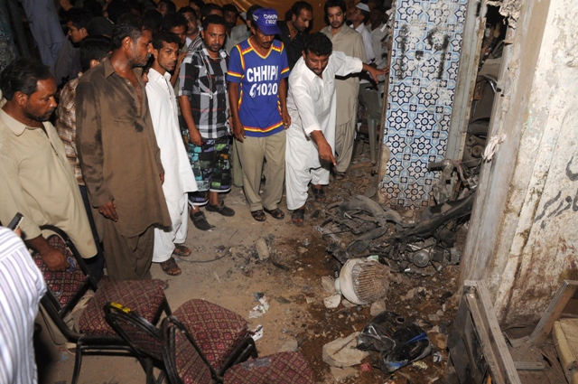 ppp supporters inspect the motorcycle which had the bomb planted on it photo afp