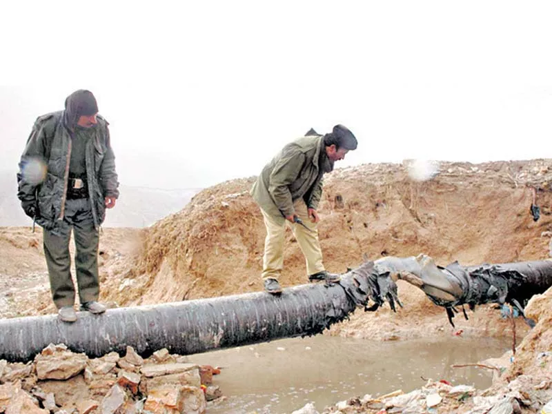 this file photo shows two security officials inspecting a section of a gas pipeline blown up by militants in balochistan this file photo shows two security officials inspecting a section of a gas pipeline blown up by militants in balochistan