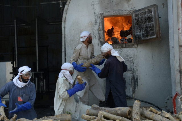 in this photograph taken on april 19 2013 pakistani workers use fire wood to run the boiler at the kohinoor textiles factory in rawalpindi photo afp