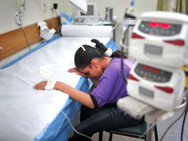 a girl who was injured in the blast waits to receive treatment at a hospital photo reuters