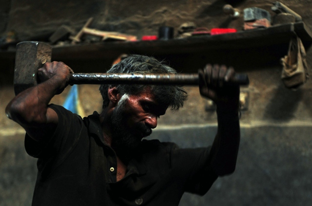 a pakistani labourer works at an iron factory in karachi on april 30 2013   the eve of international labour day photo afp