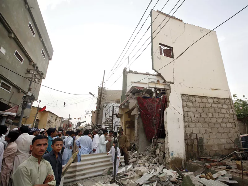 people gather outside a house in mominabad which was destroyed when a bomb went off last friday near anp s corner meeting people gather outside a house in mominabad which was destroyed when a bomb went off last friday near anp s corner meeting
