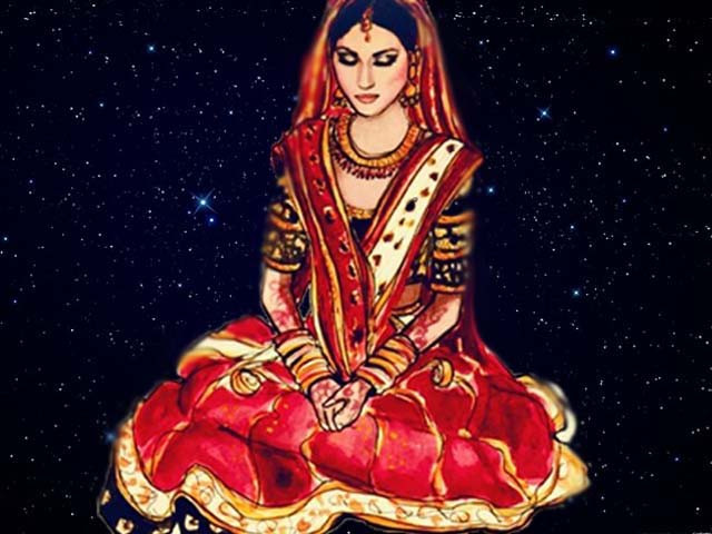 her gown was stitched out of a deep red shade of velvet and intricate golden patterns were embroidered at the bottom