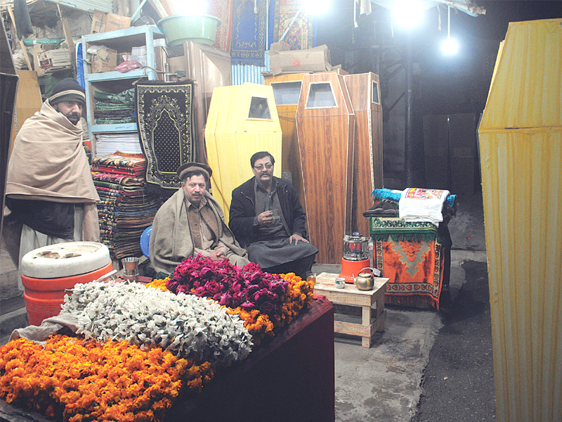 only a city like peshawar would need a 24 hour coffin maker and man with the stomach to do the job photo by muhammad iqbal