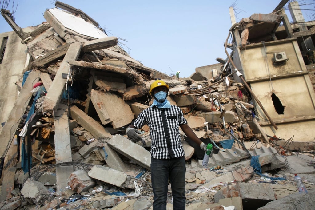 a rescue worker stands in front of the rubble of the collapsed rana plaza building in savar 30 km 19 miles outside dhaka april 26 2013 photo reuters