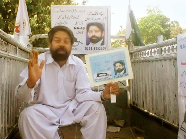 julius salik sits in a suzuki pickup van which he has converted into an election office photo azam khan express