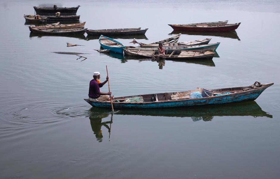 a fisherman with a henna dyed beard rows a boat out in karachi 039 s china creek pakistan photo reuters