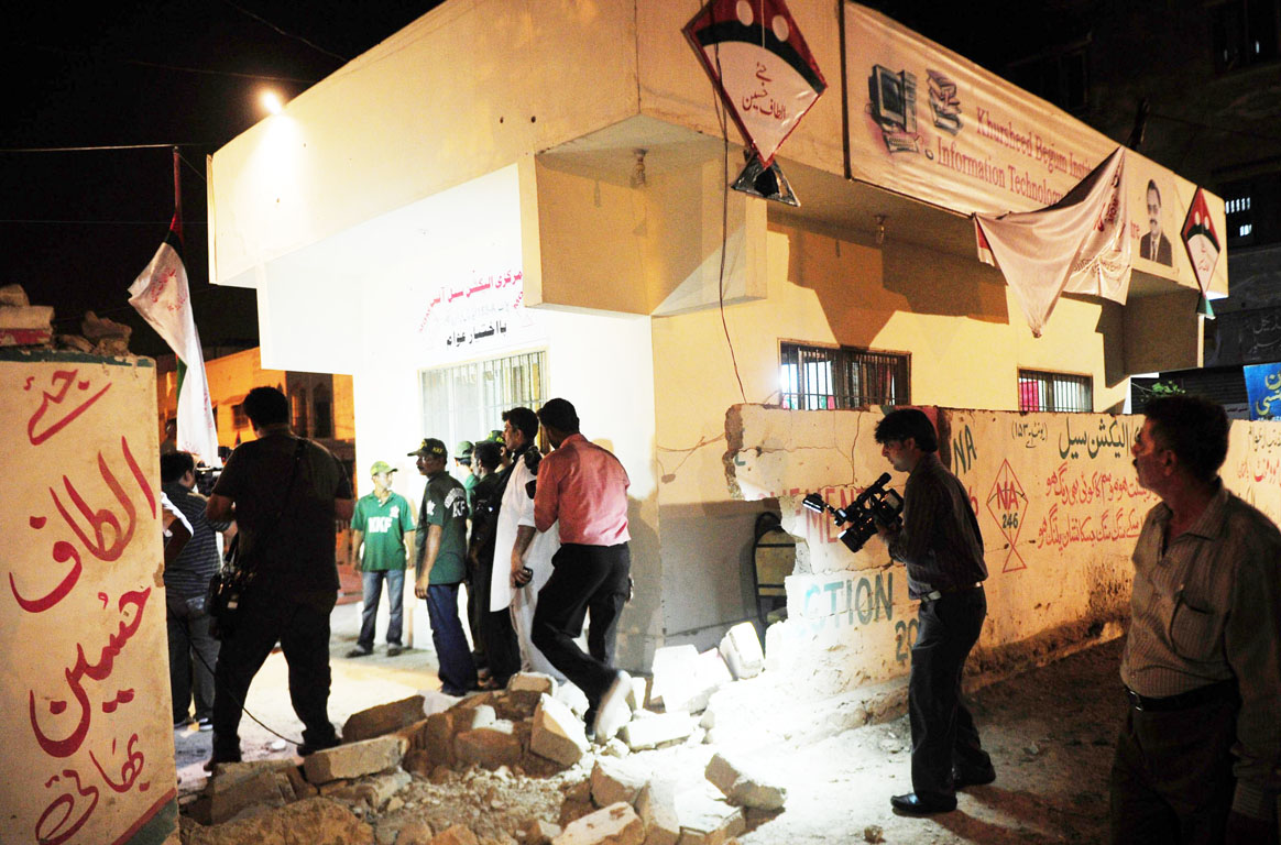 media officials record video the site of twin bomb blasts near the muttahida qaumi movement mqm party office in karachi on may 4 2013 photo afp