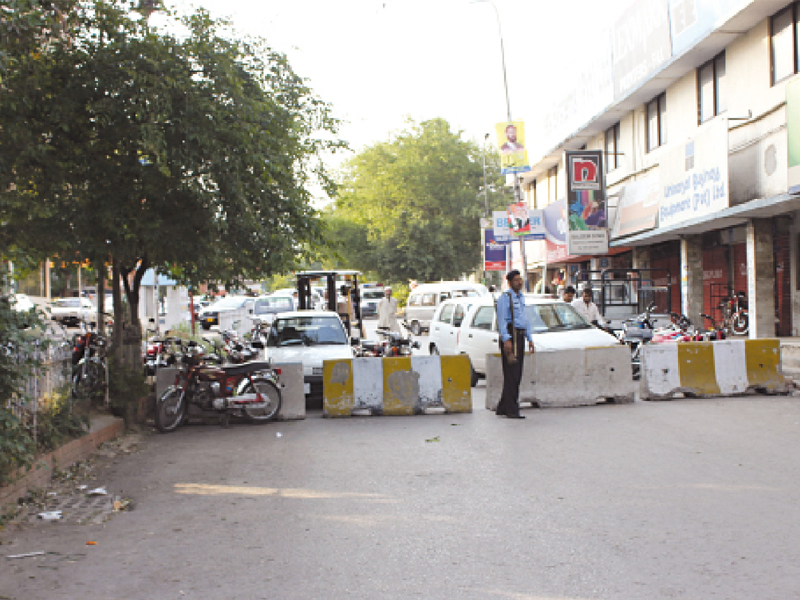 concrete blocks set up at a road leading to khayaban i suhrawardy on sunday photo waqas naeem