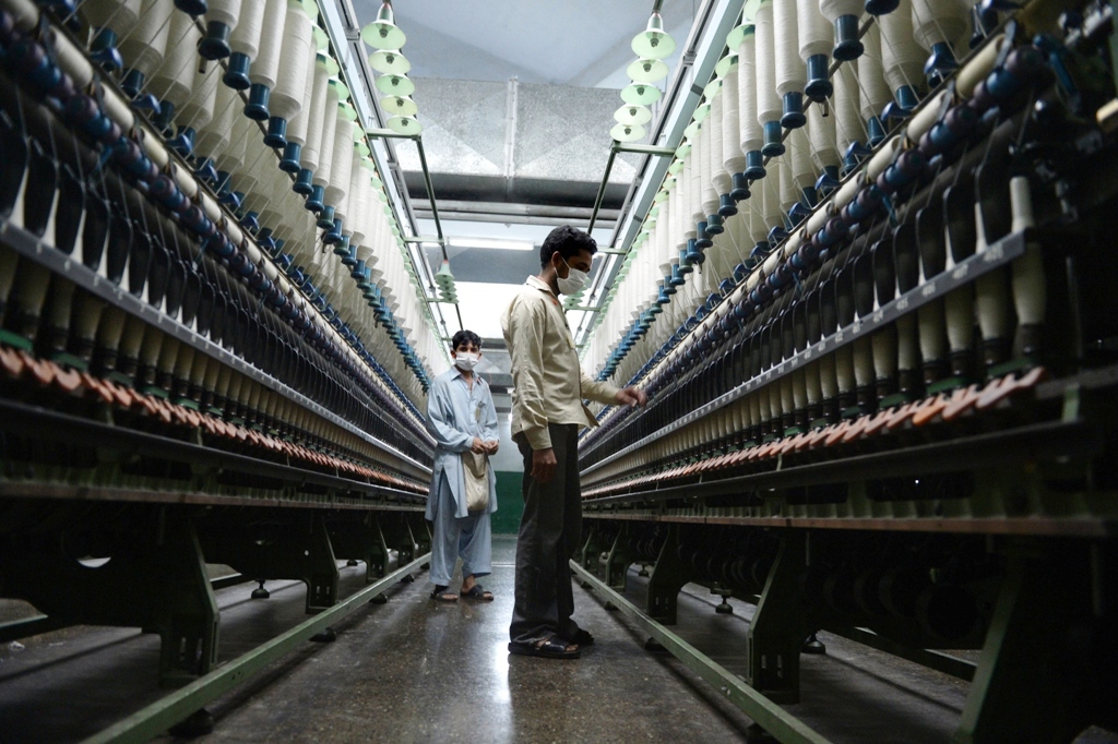 in this photograph taken on april 19 2013 pakistani workers carry out their daily work at the kohinoor textiles factory in rawalpindi photo afp