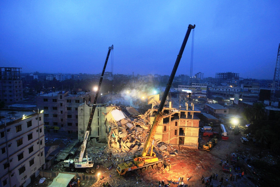 in this photograph taken on april 29 2013 cranes operated by bangladeshi army personnel are pictured at the scene following the april 24 collapse of an eight storey building in savar on the outskirts of dhaka photo afp